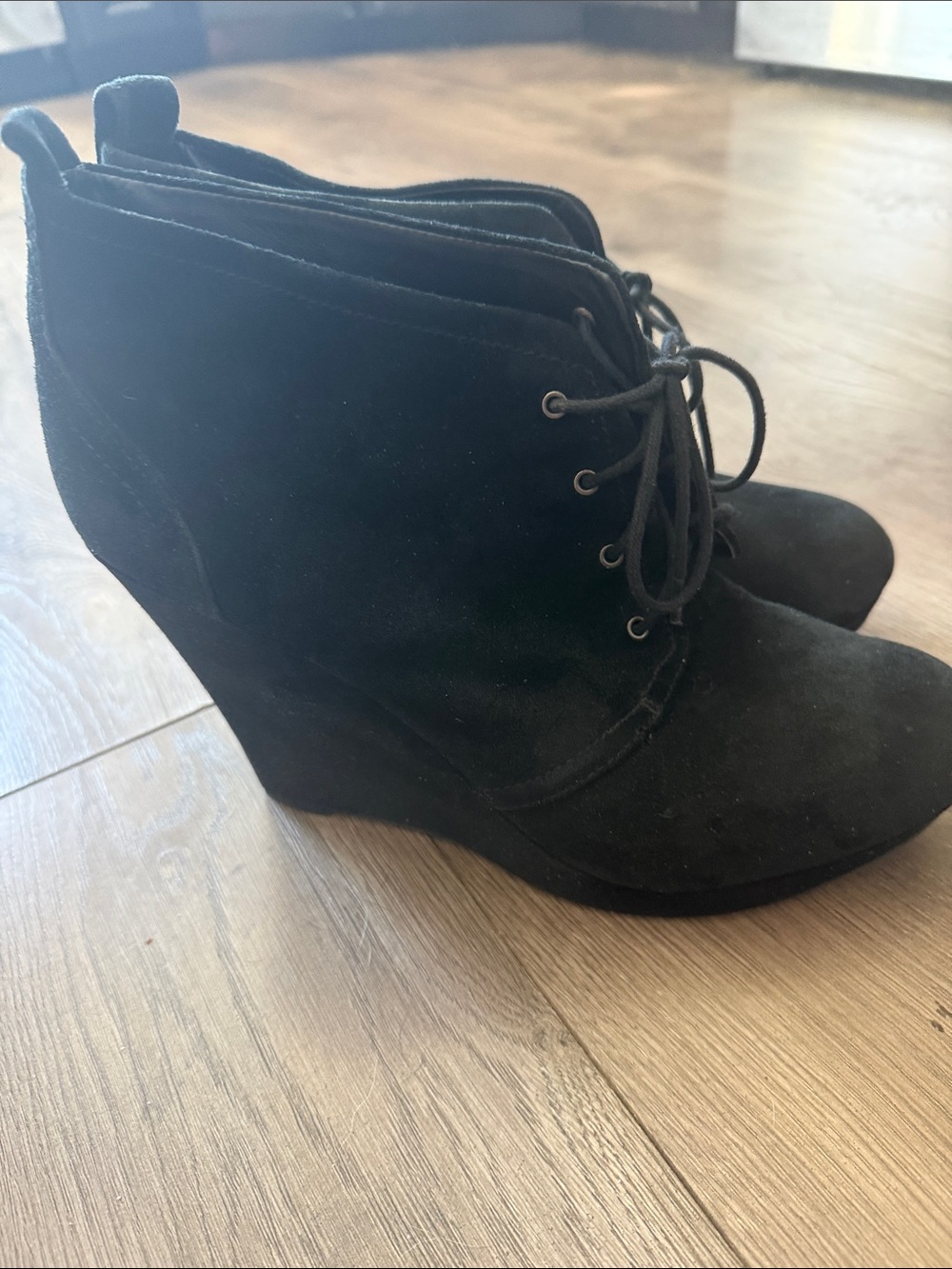 Jessica Simpson Catcher black suede lace-up wedge booties with a platform sole.
